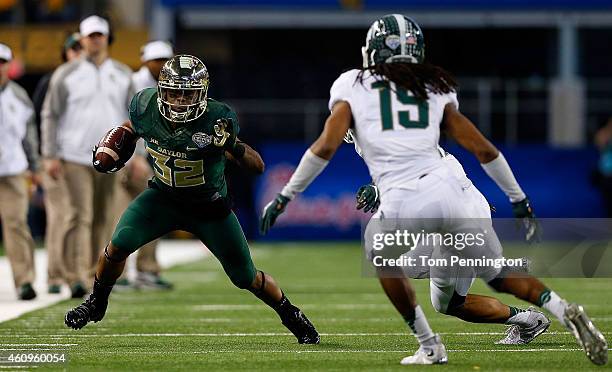 Shock Linwood of the Baylor Bears tries to run past Kurtis Drummond of the Michigan State Spartans and Trae Waynes of the Michigan State Spartans...