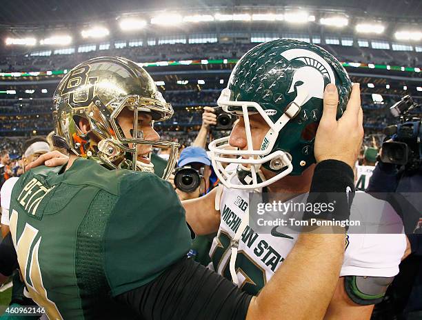 Bryce Petty of the Baylor Bears talks with Connor Cook of the Michigan State Spartans at midfield after the Spartains beat the Bears 42-41 during the...