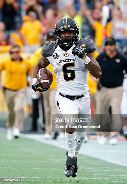 Marcus Murphy of the Missouri Tigers runs for yardage during the Buffalo Wild Wings Citrus Bowl against the Minnesota Golden Gophers at the Florida...