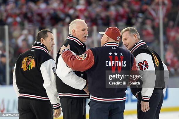 Head coach of the Chicago Blackhawks Joel Quenneville, with assistant coaches Kevin Dineen and Mike Kitchen, shakes hands with the Washington...