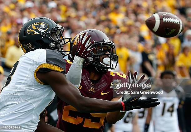 Darius White of the Missouri Tigers attempts a reception against Briean Boddy-Calhoun of the Minnesota Golden Gophers during the Buffalo Wild Wings...
