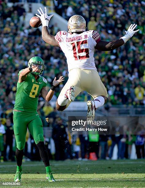 Defensive end Mario Edwards Jr. #15 of the Florida State Seminoles attempts to block a pass by quarterback Marcus Mariota of the Oregon Ducks during...