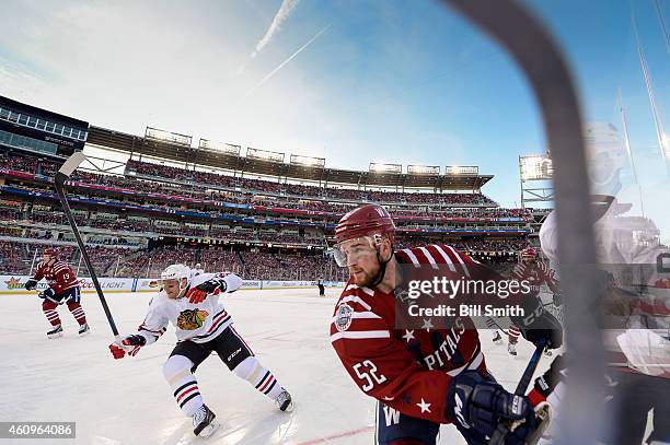 Mike Green of the Washington Capitals and Marian Hossa of the Chicago Blackhawks skate around the boards during the 2015 Bridgestone NHL Winter...