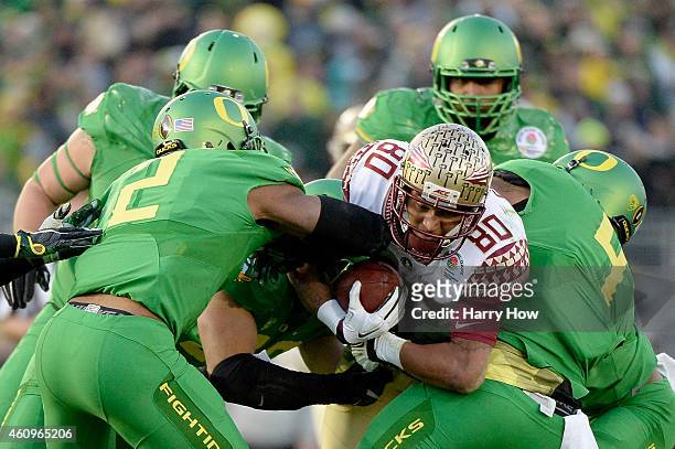 Wide receiver Rashad Greene of the Florida State Seminoles is tackled by the Oregon Ducks in the third quarter during the College Football Playoff...