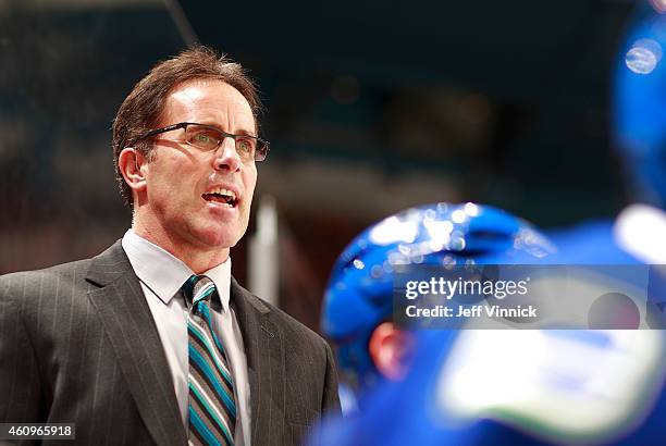 Assistant coach Doug Lidster of the Vancouver Canucks looks on from the bench during their NHL game against the Dallas Stars at Rogers Arena December...