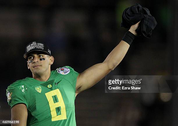 Quarterback Marcus Mariota of the Oregon Ducks reacts after defeating the Florida State Seminoles 59-20 in the College Football Playoff Semifinal at...