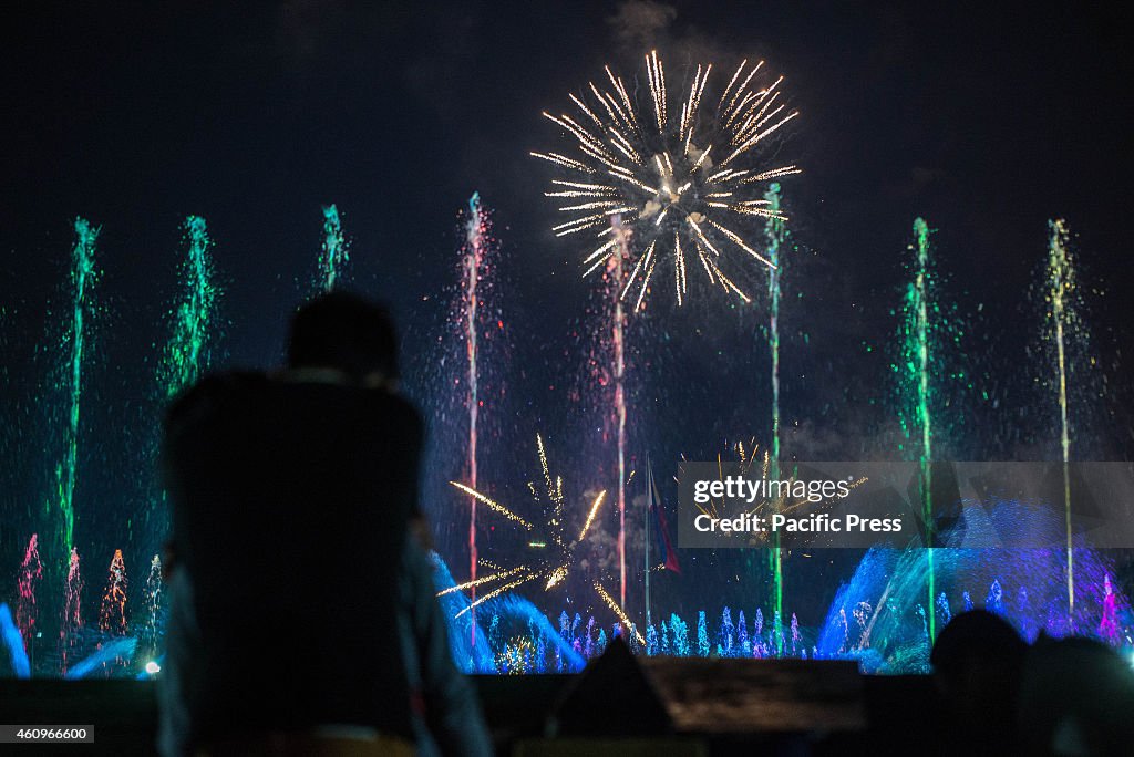 A couple hug each other while watching the fireworks display...