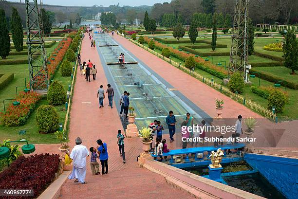 Tourists at Brindavan Gardens. The Brindavana Gardens is built across the river Kaveri. The work on laying out this garden was started in the year...