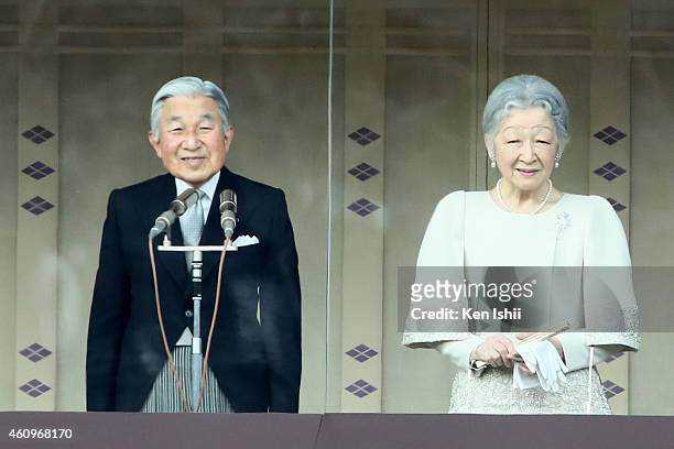 Emperor Akihito speaks to well-wishers next to Empress Michiko during the celebration for the New Year on the veranda of the Imperial Palace on...