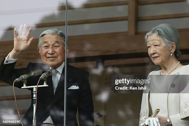 Emperor Akihito waves to well-wishers next to Empress Michiko during the celebration for the New Year on the veranda of the Imperial Palace on...