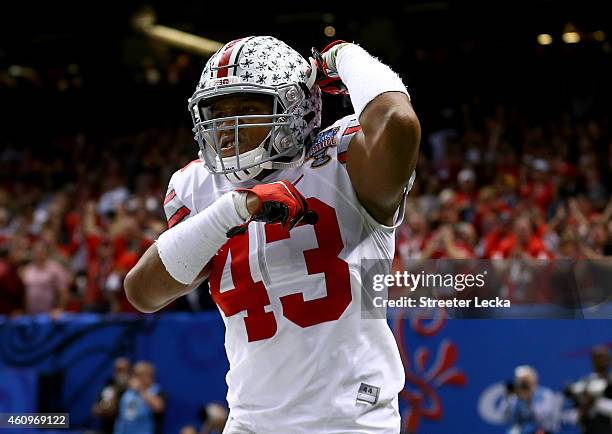 Darron Lee celebrates teammate Steve Miller of the Ohio State Buckeyes after scoring a 41 yard interception return from Blake Sims of the Alabama...