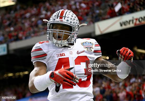 Darron Lee celebrates teammate Steve Miller of the Ohio State Buckeyes after scoring a 41 yard interception return from Blake Sims of the Alabama...