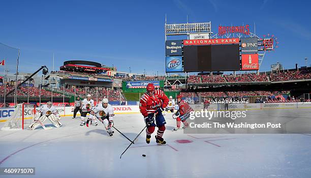 Washington left wing Alex Ovechkin controls the puck during the first period of the NHL Winter Classic between the Washington Capitals and the...