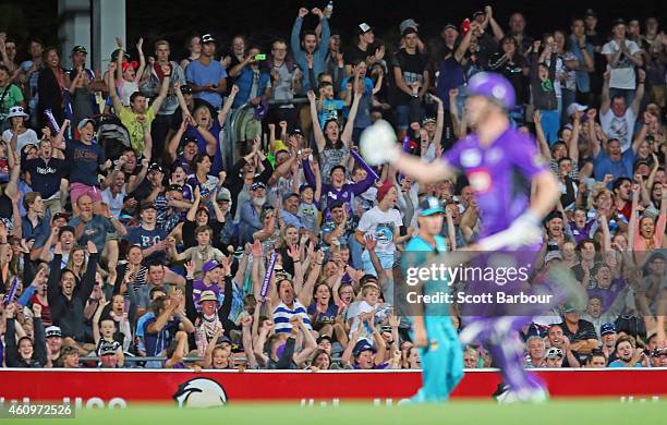 The crowd celebrates as George Bailey of the Hurricanes hits the winning runs during the Big Bash League match between the Hobart Hurricanes and the...