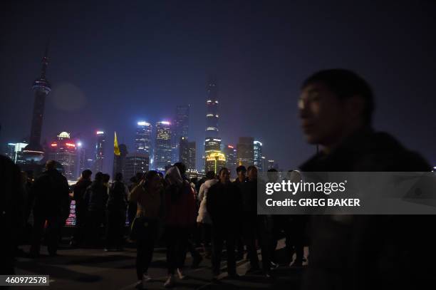 People walk on Shanghai's waterfront Bund, near the site of the New Year's Eve stampede in Shanghai on January 2, 2015. The New Year's stampede just...