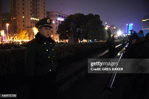 Paramilitary police officer stands guard above the site of the New Year's Eve stampede in Shanghai on January 2, 2015. The New Year's stampede just...