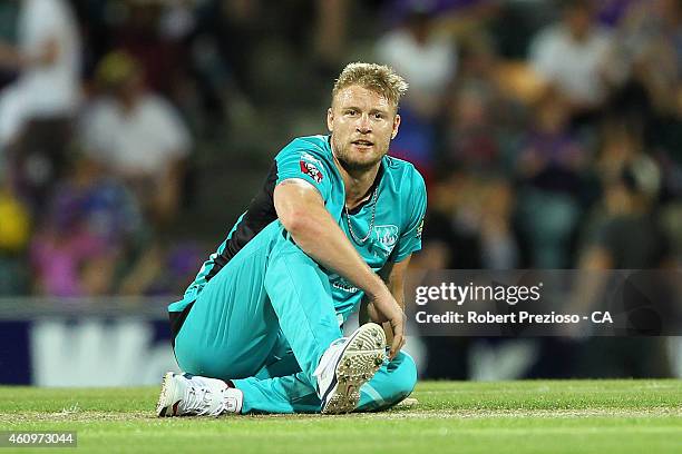 Andrew Flintoff of the Heat goes to ground after bowling during the Big Bash League match between the Hobart Hurricanes and the Brisbane Heat at...