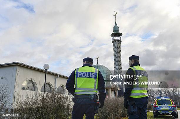 Policemen stand outside a mosque in Uppsala on January 2, 2015. The mosque suffered a firebomb attack on January 1, one of three arson attacks...