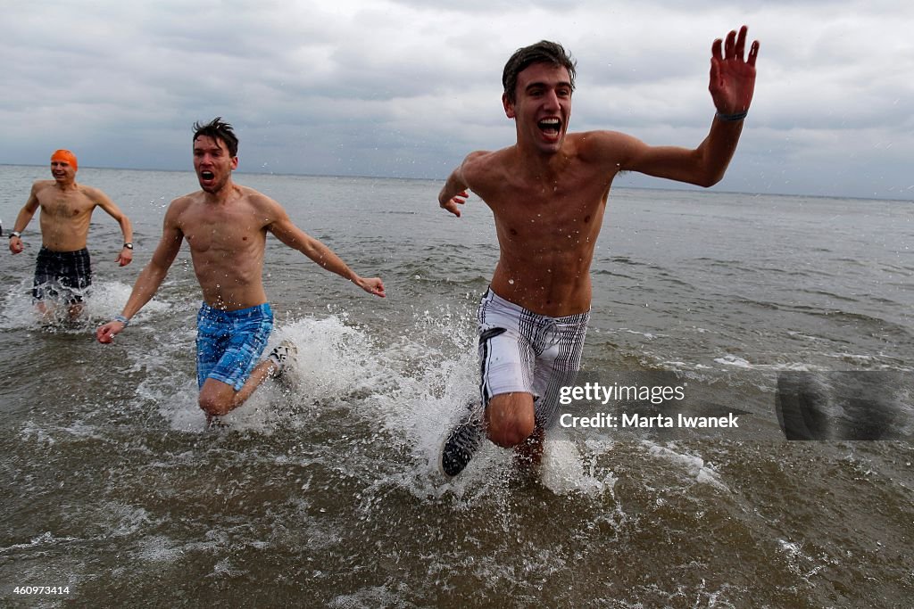 People run into Lake Ontario during The Courage Polar Bear Dip for World Vision held at Coronation Park