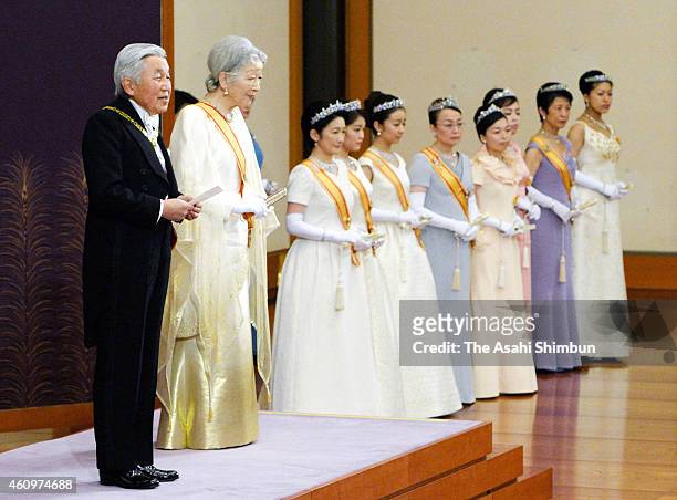 Emperor Akihito greets while Empress Michiko and other royal members listen during the 'Shinnen-Shukuga-no-Gi' ceremony to celebrate the New Year at...