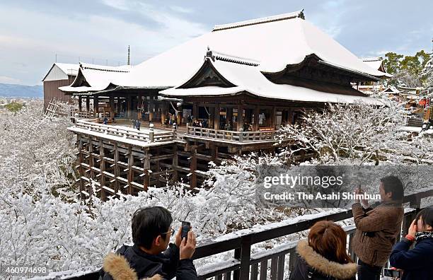 Visitors take photographs of snow-covered Kiyomizudera Temple on January 2, 2014 in Kyoto, Japan. The Japan Meteorological Agency have warned heavy...