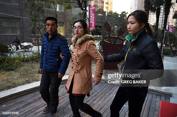 Li Juan , Li Biaojiu and Luo Liuying, relatives of Li Na, who died in a stampede on New Year's Eve, walk to a government compound in Shanghai on...