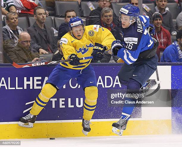 Julius Bergman of Team Sweden slams into Mikko Rantanen of Team Finland during a quarter-final game in the 2015 IIHF World Junior hockey championship...