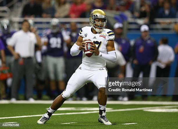 Brett Hundley of the UCLA Bruins throws the ball against the Kansas State Wildcats in the first quarter during the Valero Alamo Bowl at Alamodome on...
