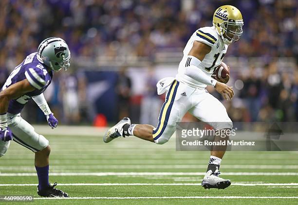 Brett Hundley of the UCLA Bruins runs for a touchdown past Nate Jackson of the Kansas State Wildcats in the first quarter during the Valero Alamo...