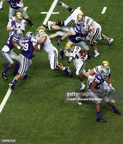 Paul Perkins of the UCLA Bruins runs for a touchdown against the Kansas State Wildcats in the second quarter during the Valero Alamo Bowl at...