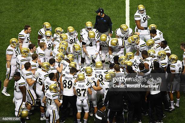 The UCLA Bruins huddle up after a touchdown against the Kansas State Wildcats in the second quarter during the Valero Alamo Bowl at Alamodome on...