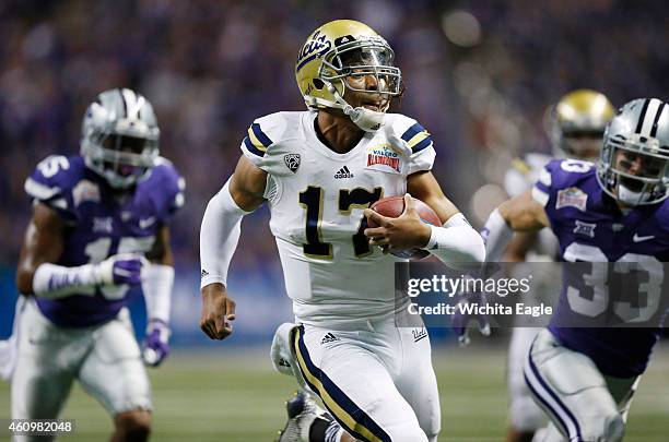 Quarterback Brett Hundley runs for a 28-yard touchdown in the first quarter against Kansas State in the Valero Alamo Bowl at the Alamodome in San...