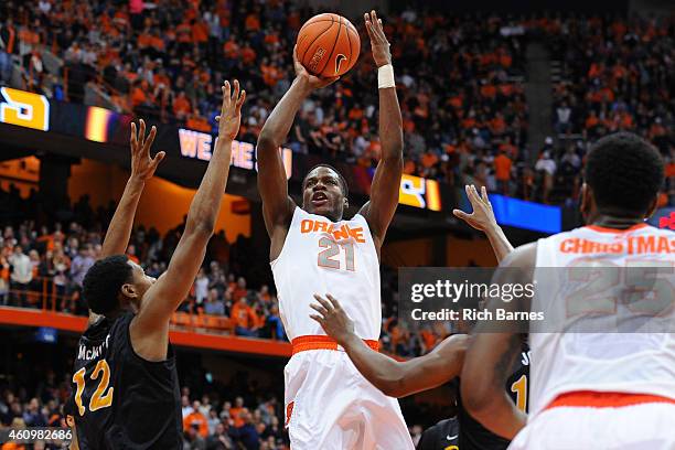 Tyler Roberson of the Syracuse Orange shoots the ball over Eric McKnight of the Long Beach State 49ers during the second half at the Carrier Dome on...