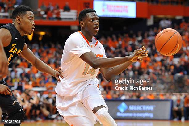 Kaleb Joseph of the Syracuse Orange makes a pass as Mike Caffey of the Long Beach State 49ers defends during the second half at the Carrier Dome on...
