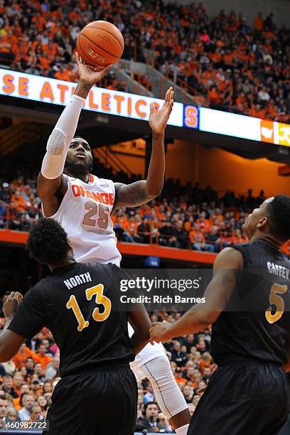 Rakeem Christmas of the Syracuse Orange shoots the ball over Deontae North and Mike Caffey of the Long Beach State 49ers during the second half at...