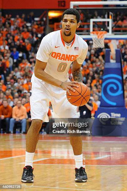 Michael Gbinije of the Syracuse Orange controls the ball against the Long Beach State 49ers during the second half at the Carrier Dome on December...