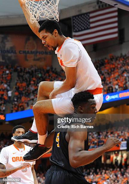 Michael Gbinije of the Syracuse Orange reacts after a dunk over Temidayo Yussuf of the Long Beach State 49ers during the first half at the Carrier...