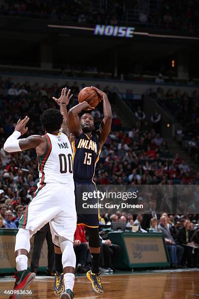 Donald Sloan of the Indiana Pacers shoots against O.J. Mayo of the Milwaukee Bucks on January 2, 2015 at the BMO Harris Bradley Center in Milwaukee,...