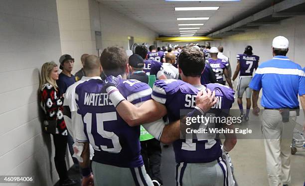 Kansas State quarterback Jake Waters and wide receiver Curry Sexton make the long walk back to the locker room after a 40-35 loss against UCLA in the...