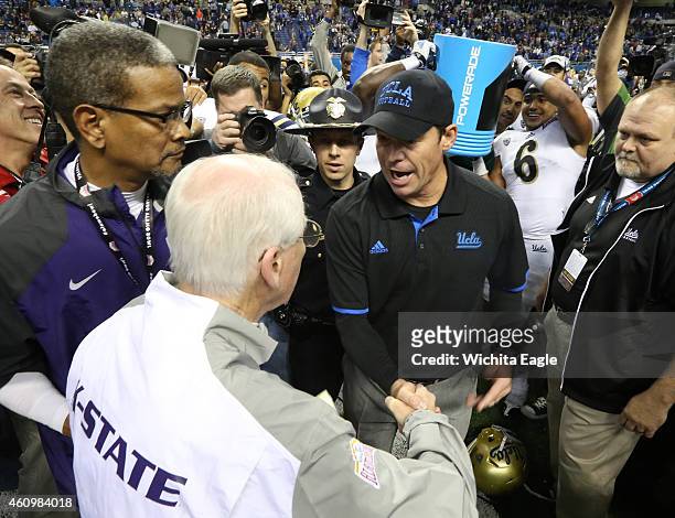 Kansas State head coach Bill Snyder, left, shakes hands with UCLA head coach Jim Mora after the Valero Alamo Bowl at the Alamodome in San Antonio on...