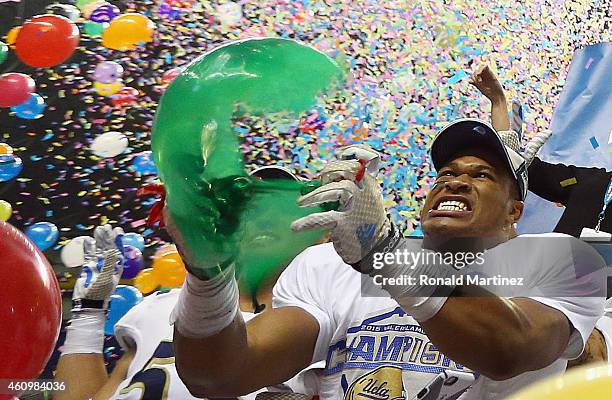 Kenny Young of the UCLA Bruins pops a ballon after a 40-35 win against the Kansas State Wildcats during the Valero Alamo Bowl at Alamodome on January...