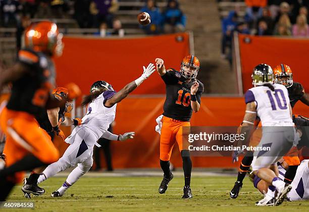 Quarterback Mason Rudolph of the Oklahoma State Cowboys throws a pass during the first quarter of the TicketCity Cactus Bowl against the Washington...