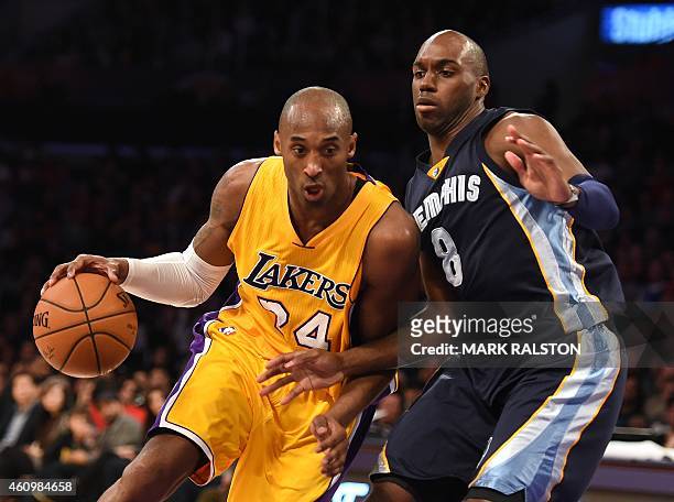 Kobe Bryant of the Los Angeles Lakers drives against Quincy Pondexter of the Memphis Grizzlies during their NBA game 33 at the Staples Center in Los...