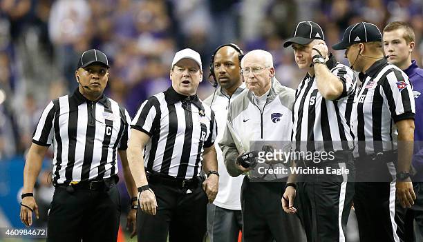 Kansas State head coach Bill Snyder gathers with most the officials to discuss a penalty in the fourth quarter in the Valero Alamo Bowl against UCLA...