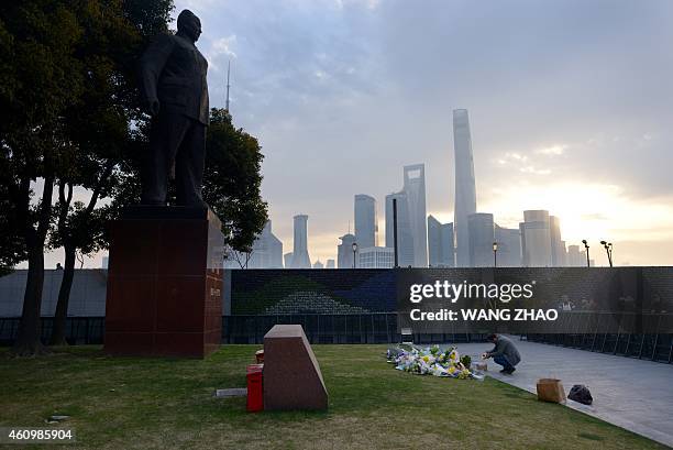 Man prays for the victims at the site of the New Year's Eve stampede in Shanghai on January 3, 2015. The New Year's stampede just before midnight on...