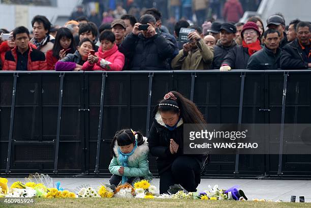 Family pray for the victims at the site of the New Year's Eve stampede in Shanghai on January 3, 2015. The New Year's stampede just before midnight...
