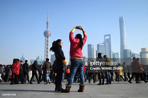 People visit Shanghai's waterfront Bund, near the site of the New Year's Eve stampede in Shanghai on January 3, 2015. The New Year's stampede just...