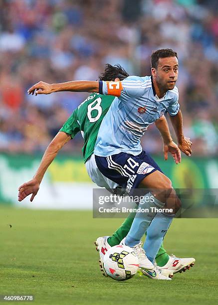 Alex Brosque of Sydney competes with Zenon Caravella of the Jets during the round 15 A-League match between Sydney FC and Newcastle Jets at WIN...