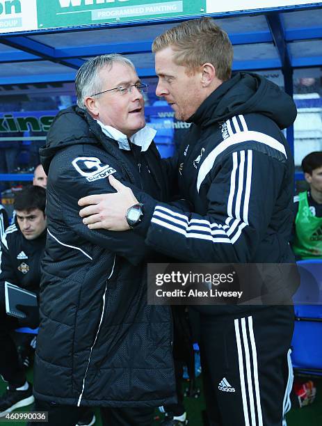 Micky Adams, manager of Tranmere greets Garry Monk, manager of Swansea City during the FA Cup Third Round match between Tranmere Rovers and Swansea...