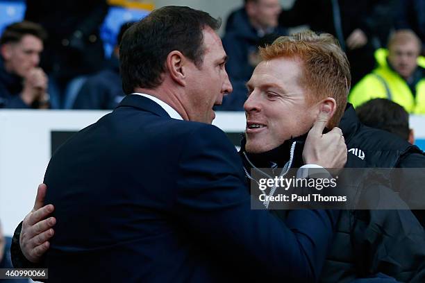 Manager Neil Lennon of Bolton hugs Manager Malky Mackay of Wigan during the FA Cup Third Round match between Bolton Wanderers and Wigan Athletic at...